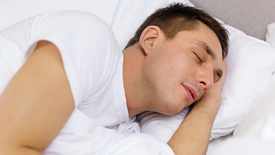 Man sleeping soundly in bed
