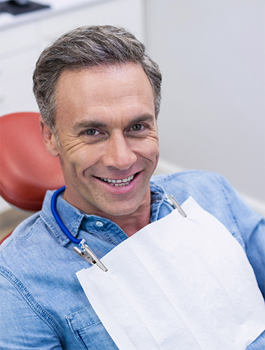 Man in a denim shirt at the dentist