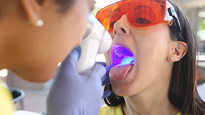 Woman receiving oral cancer screening