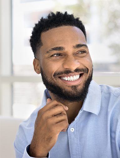 Smiling man in a light blue button-down shirt