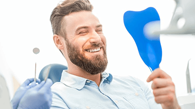 a patient smiling after undergoing a teeth whitening treatment