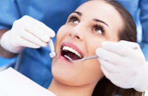 happy woman recieve crown & bridge treatment from the general dentist Irving, TX trusts