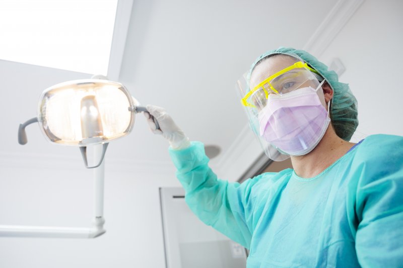Dentist wearing protective mask and face gear for COVID-19 protection