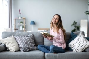 Woman relaxing on her couch while smiling