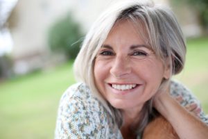 Woman with dental implants smiling.