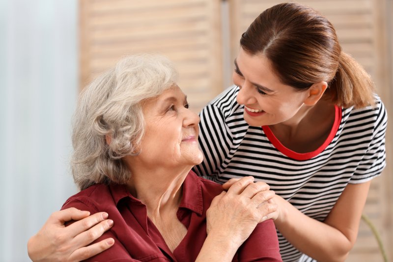 a woman caring for a patient with Alzheimer’s disease