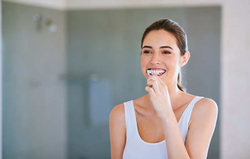 woman brushing her teeth