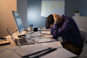 a stressed person sitting at a desk