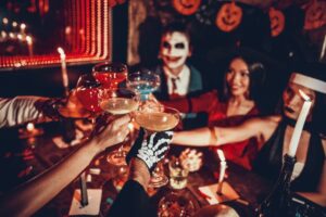 Group of friends enjoying a drink at a Halloween party
