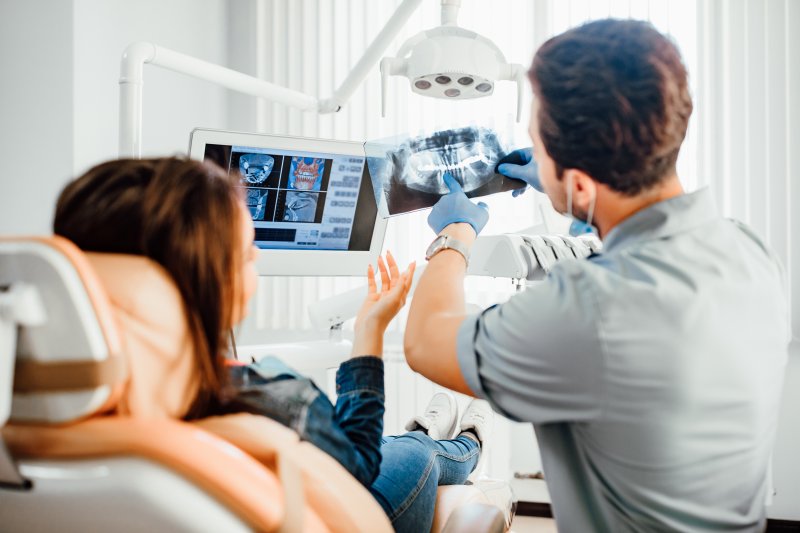 A dentist showing a dental X-ray to a patient