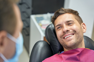a patient smiling and chatting with their dentist